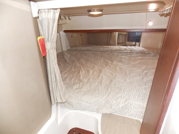  Yacht Photos Pics Cabin interior of 2015 Grady-White Express 370 with cozy bed and curtain.