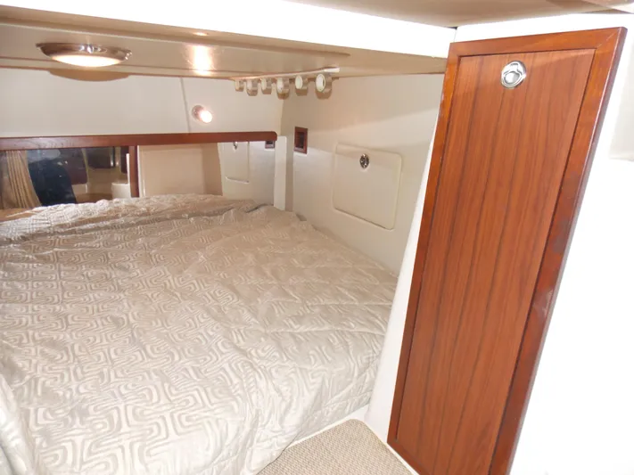  Yacht Photos Pics 2015 Grady-White Express 370 cabin interior with bed and wooden cabinetry.