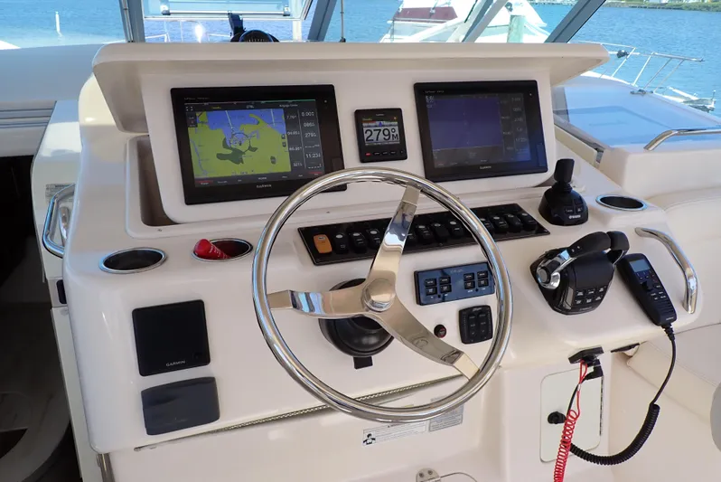  Yacht Photos Pics Control panel of 2015 Grady-White Express 370 boat with navigation screens and steering wheel.