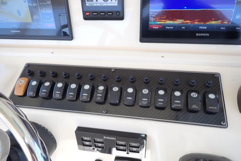  Yacht Photos Pics Control panel of a 2015 Grady-White Express 370 boat with various switches and displays.