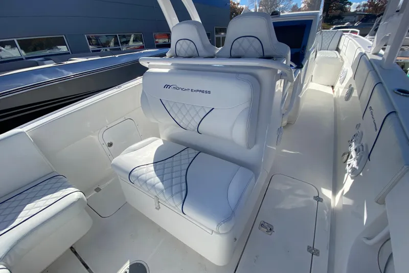  Yacht Photos Pics 2017 Midnight Express 39S Cuddy boat interior with white cushioned seating and sleek design.
