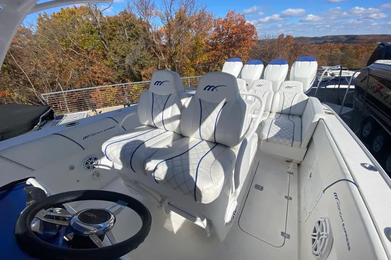  Yacht Photos Pics 2017 Midnight Express 39S Cuddy boat interior with white seating and steering wheel.