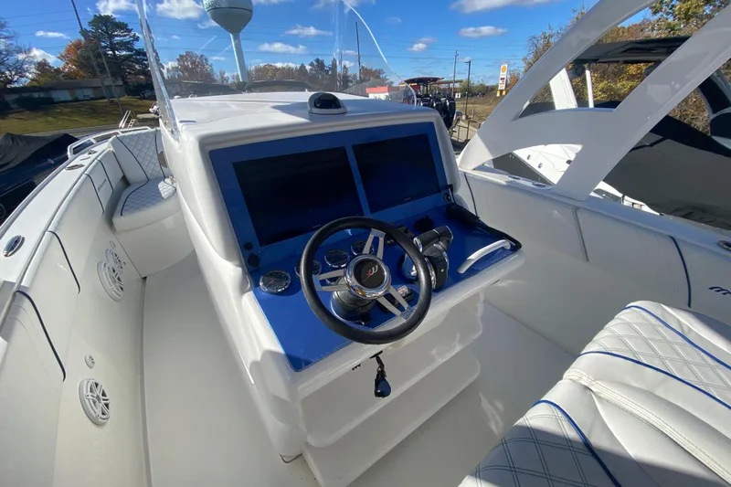  Yacht Photos Pics 2017 Midnight Express 39S Cuddy boat cockpit with steering wheel and navigation screens.