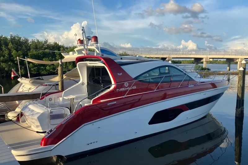  Yacht Photos Pics 2020 Azimut Nexus X47 yacht docked by a scenic waterfront under a blue sky.