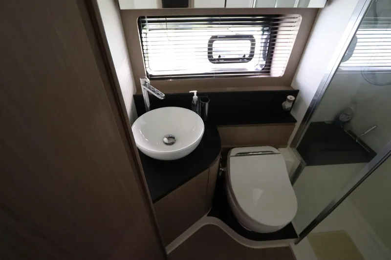  Yacht Photos Pics Modern bathroom in 2020 Azimut Nexus X47 yacht with sink, toilet, and window blinds.