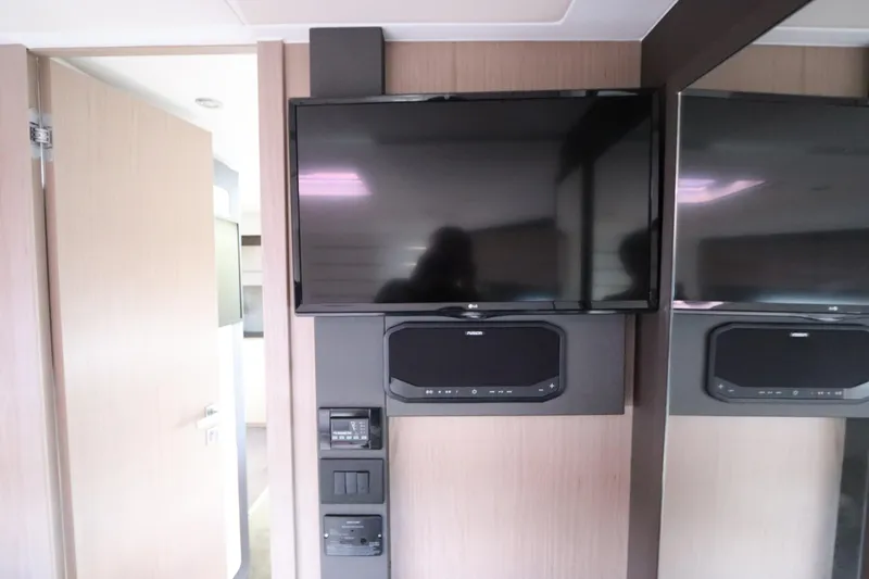  Yacht Photos Pics Entertainment system inside 2020 Azimut Nexus X47 yacht, featuring a mounted TV and sound system.