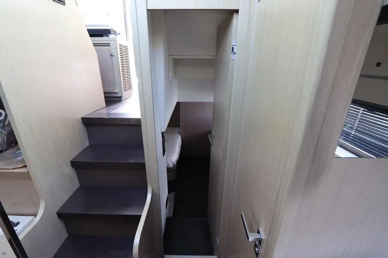  Yacht Photos Pics Interior view of 2020 Azimut Nexus X47 yacht, featuring stairs and a compact cabin space.