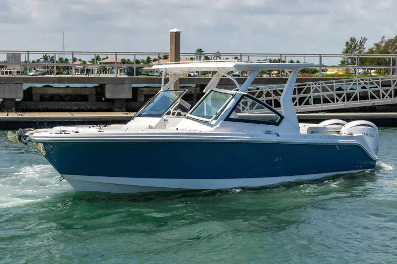  Yacht Photos Pics 2025 Edgewater 262 CX boat cruising in a marina, featuring sleek design and modern amenities.