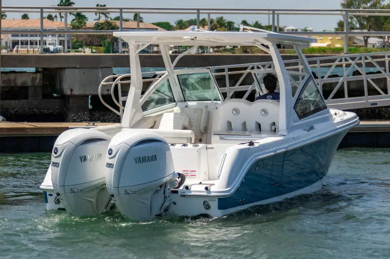  Yacht Photos Pics 2025 Edgewater 262 CX boat with dual Yamaha engines docked in a marina.
