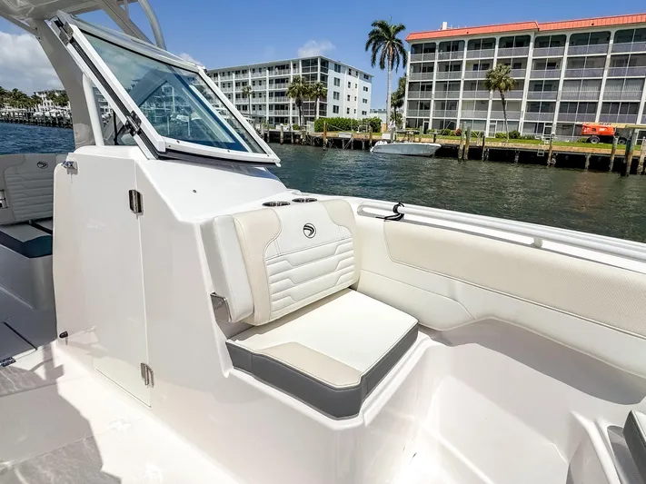  Yacht Photos Pics 2025 Edgewater 262 CX boat interior with white seating, dockside view.