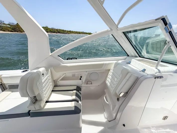  Yacht Photos Pics 2025 Edgewater 262 CX boat interior with white seating, ocean view, and sleek design.
