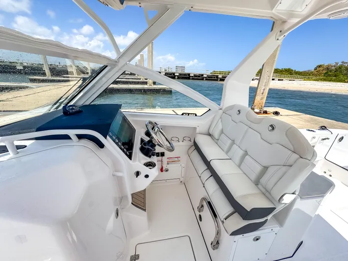  Yacht Photos Pics 2025 Edgewater 262 CX boat interior with sleek white seating and modern dashboard.