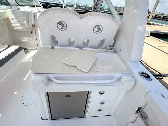  Yacht Photos Pics 2025 Edgewater 262 CX boat interior with kitchenette, sink, and storage drawers.