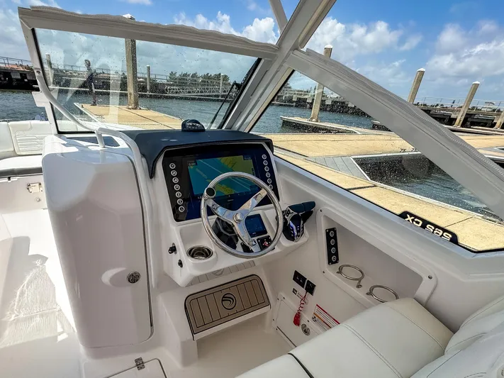  Yacht Photos Pics 2025 Edgewater 262 CX boat cockpit with modern navigation system and steering wheel.