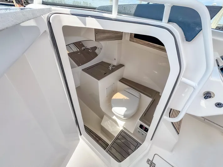  Yacht Photos Pics 2025 Edgewater 262 CX boat interior with compact bathroom and modern amenities.