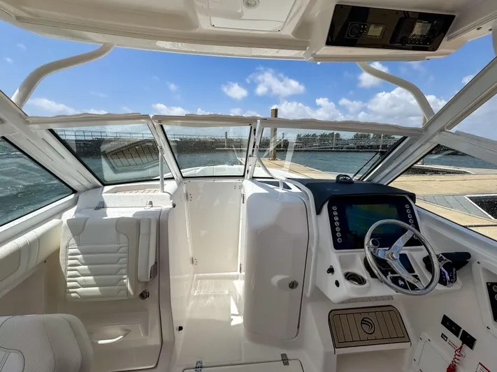 Yacht Photos Pics Interior view of 2025 Edgewater 262 CX boat with modern dashboard and steering wheel.