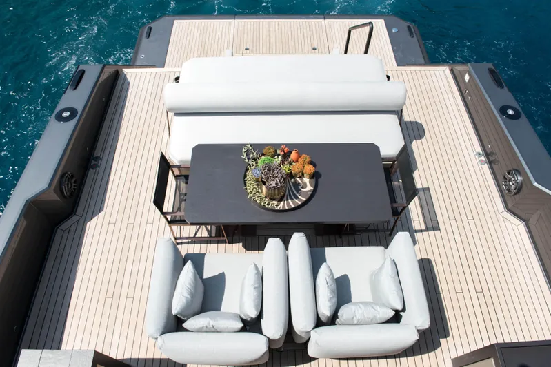  Yacht Photos Pics Luxurious deck of 2025 Mazu Yachts Mazu 82 with elegant seating and table arrangement.
