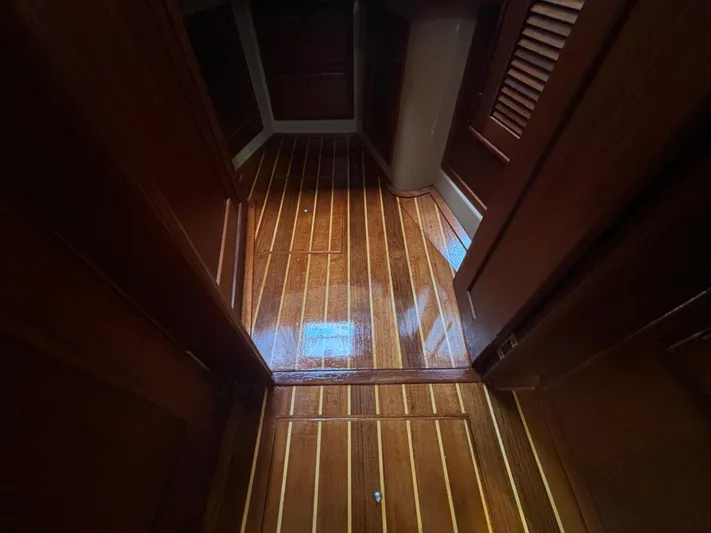 Andante Yacht Photos Pics Polished wooden floor inside a 1995 Island Packet 37 sailboat cabin.