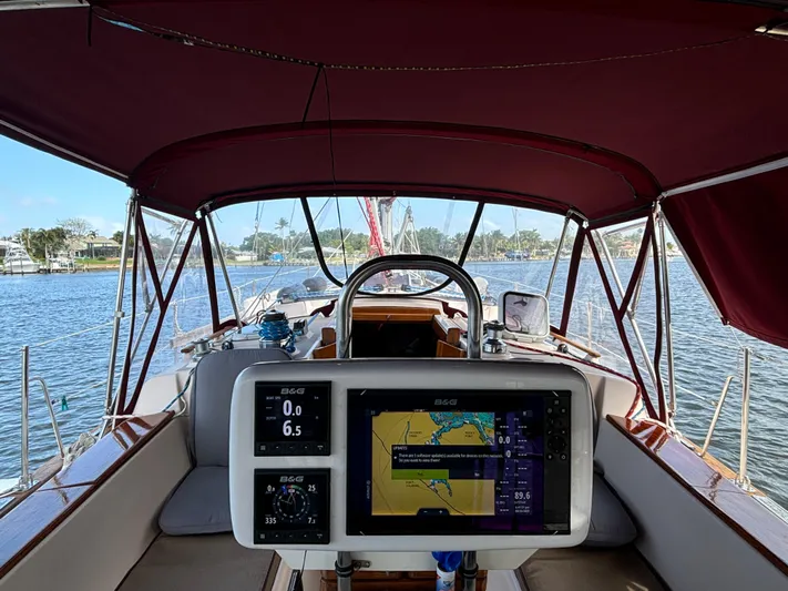 Andante Yacht Photos Pics 1995 Island Packet 37 sailboat cockpit with navigation equipment and maroon canopy.