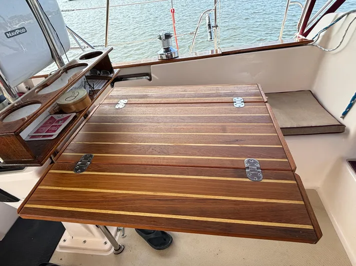 Andante Yacht Photos Pics Wooden cockpit table on a 1995 Island Packet 37 sailboat, with ocean view.