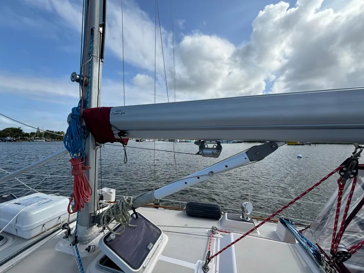 Andante Yacht Photos Pics Sailboat deck view, Island Packet 37, 1995 model, with rigging and mast against a cloudy sky.