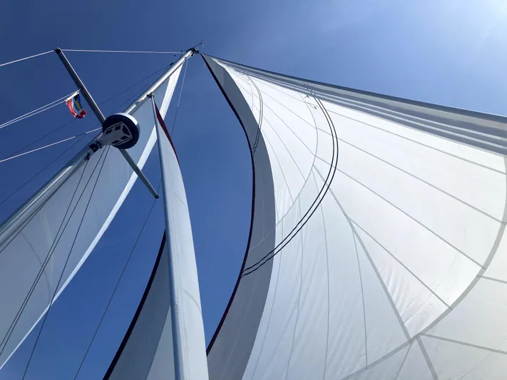 Andante Yacht Photos Pics Sails of a 1995 Island Packet 37 yacht against a clear blue sky.