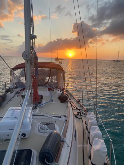 Andante Yacht Photos Pics Sailboat Island Packet 37 at sunset on calm ocean waters, 1995 model.
