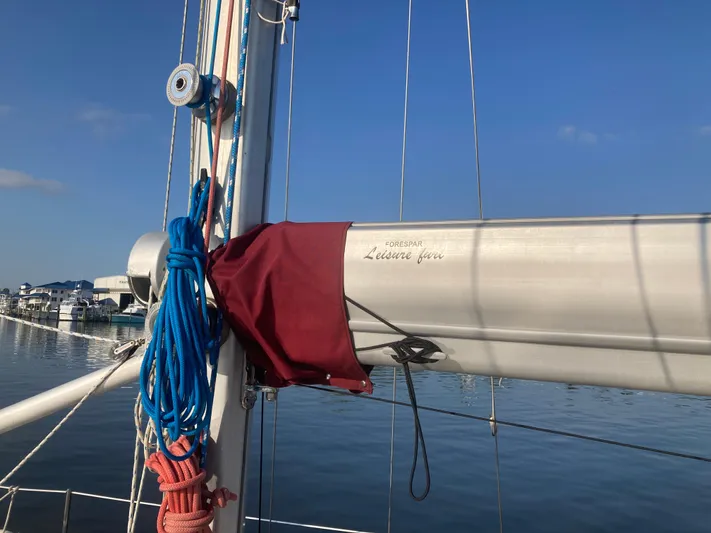 Andante Yacht Photos Pics Sailboat mast and boom of 1995 Island Packet 37, docked with blue sky background.