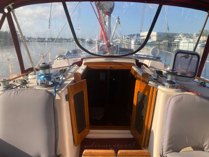 Andante Yacht Photos Pics Cockpit view of a 1995 Island Packet 37 sailboat docked at a marina.