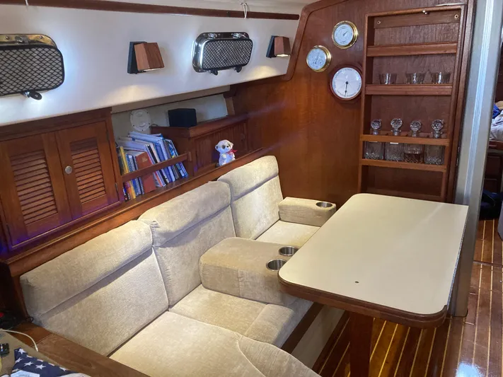 Andante Yacht Photos Pics Interior of 1995 Island Packet 37 sailboat with cozy seating and wooden accents.