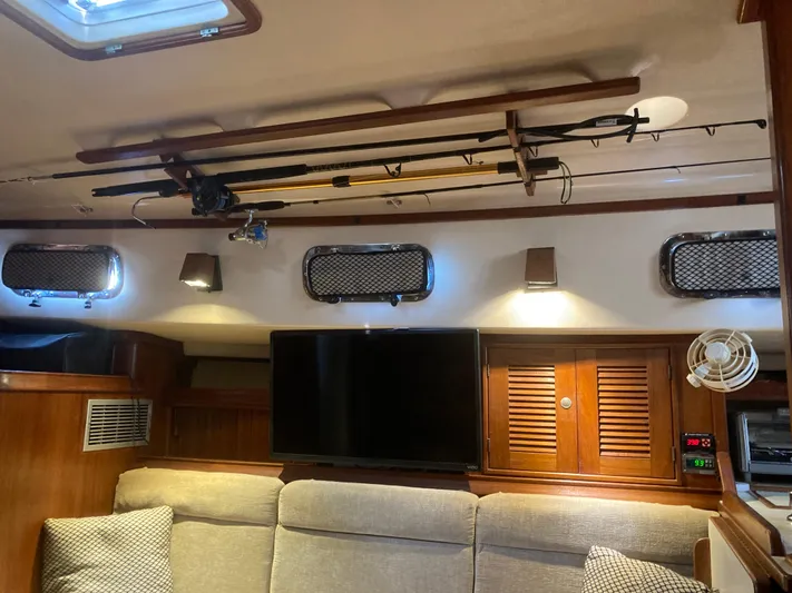 Andante Yacht Photos Pics Interior of a 1995 Island Packet 37 sailboat with cozy seating and fishing gear.