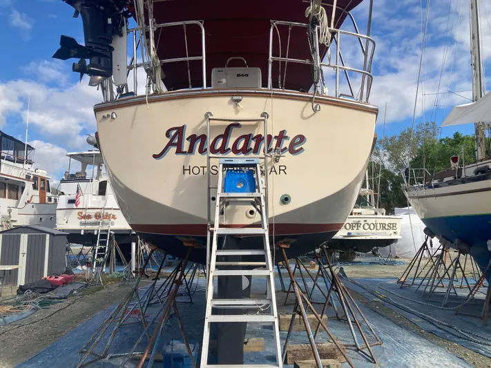 Andante Yacht Photos Pics Island Packet 37 sailboat named "Andante" on dry dock, 1995 model, with ladder access.