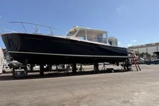 Joy! Yacht Photos Pics 2005 MJM 34z Downeast boat on dry dock under clear blue sky.