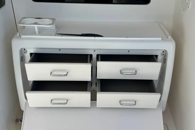 Renegade Yacht Photos Pics White storage drawers on a 2008 Cabo 35 Flybridge boat interior.