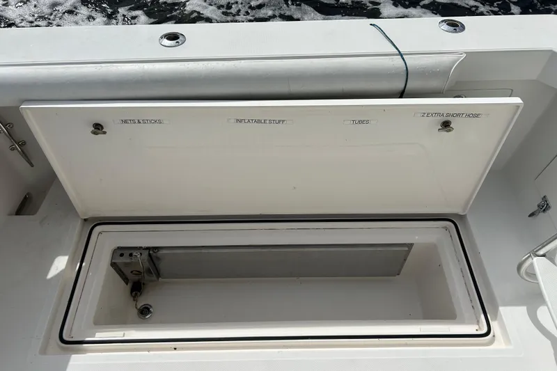 Renegade Yacht Photos Pics Open storage compartment on 2008 Cabo Yachts Sportfish 35, labeled for various equipment.