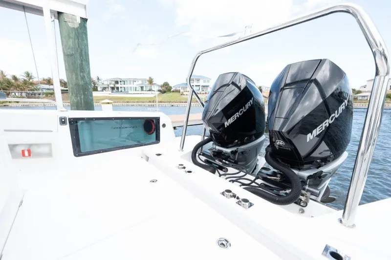  Yacht Photos Pics 2021 Axopar 37 Sun-Top with dual Mercury outboard engines docked by waterfront homes.