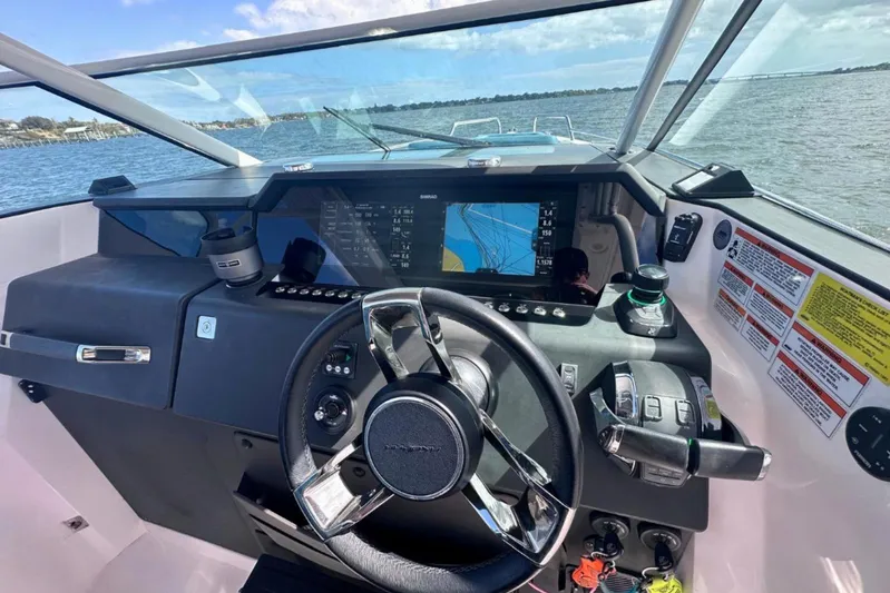  Yacht Photos Pics 2021 Axopar 37 Sun-Top boat dashboard with navigation display and controls.