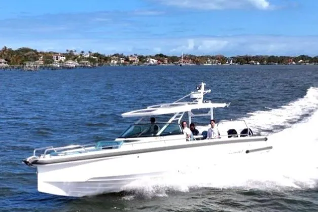  Yacht Photos Pics 2021 Axopar 37 Sun-Top cruising on a sunny day, with passengers enjoying the ride.