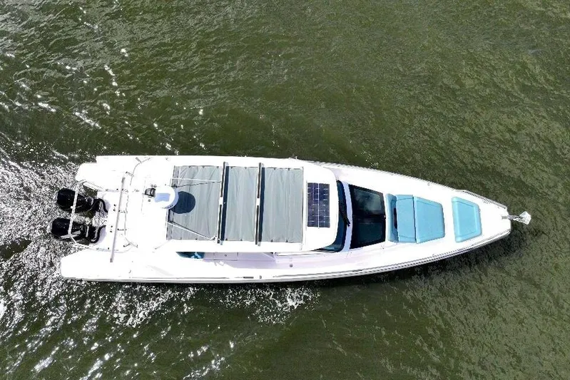  Yacht Photos Pics Aerial view of 2022 Axopar 37 Sun-Top boat cruising on water.