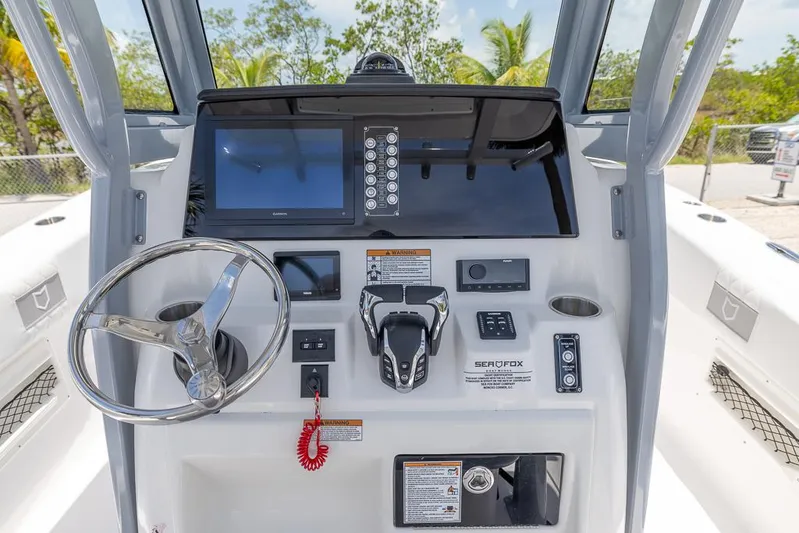 Yacht Photos Pics 2026 Sea Fox 268 Commander boat dashboard with steering wheel and navigation controls.