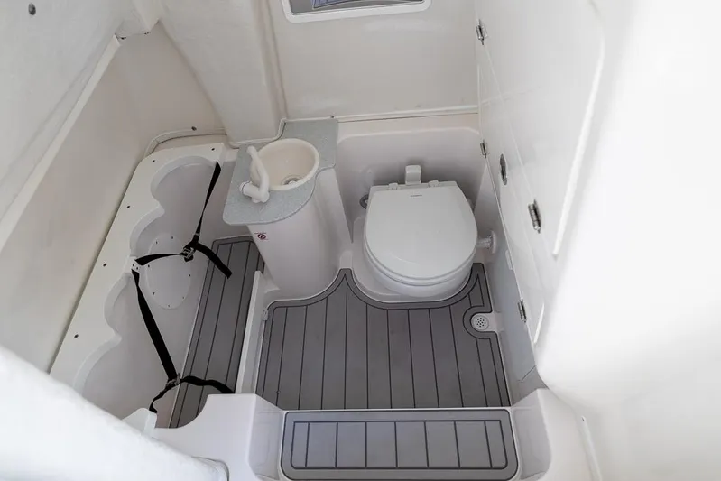  Yacht Photos Pics 2026 Sea Fox 268 Commander boat bathroom with toilet, sink, and storage.