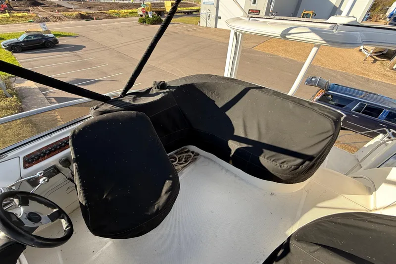Comfort Zone Yacht Photos Pics 2005 Meridian 368 Motoryacht helm with covered seating and steering wheel, docked in a marina.