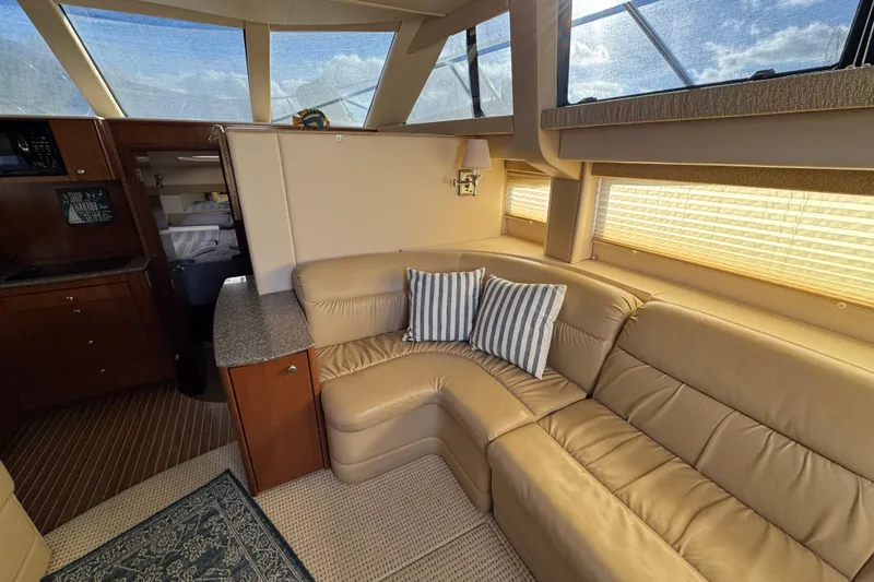 Comfort Zone Yacht Photos Pics Luxurious interior of 2005 Meridian 368 Motoryacht with leather seating and striped cushions.