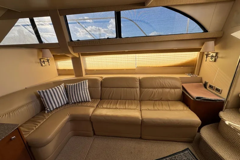 Comfort Zone Yacht Photos Pics Luxurious interior of 2005 Meridian 368 Motoryacht with leather seating and striped cushions.