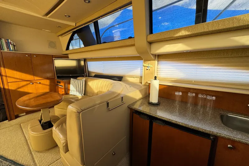 Comfort Zone Yacht Photos Pics Luxurious interior of 2005 Meridian 368 Motoryacht with seating, table, and kitchenette.