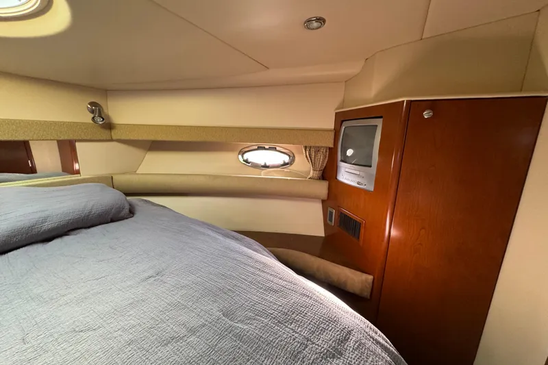 Comfort Zone Yacht Photos Pics Interior of 2005 Meridian 368 Motoryacht with bed, porthole, and built-in TV.