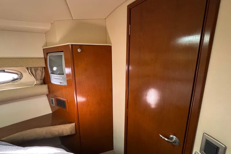Comfort Zone Yacht Photos Pics Interior of 2005 Meridian 368 Motoryacht with wood paneling and built-in TV.