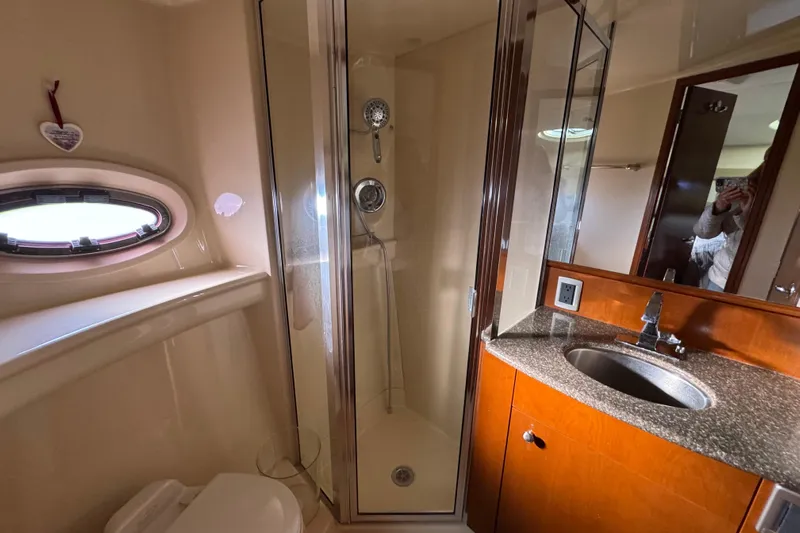 Comfort Zone Yacht Photos Pics Luxurious bathroom in 2005 Meridian 368 Motoryacht with shower, sink, and porthole window.