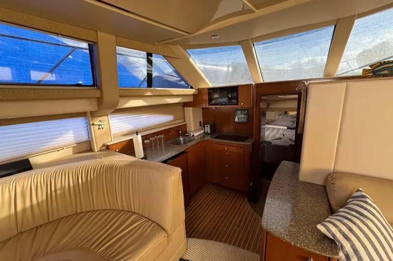 Comfort Zone Yacht Photos Pics Luxurious interior of 2005 Meridian 368 Motoryacht with kitchen and seating area.