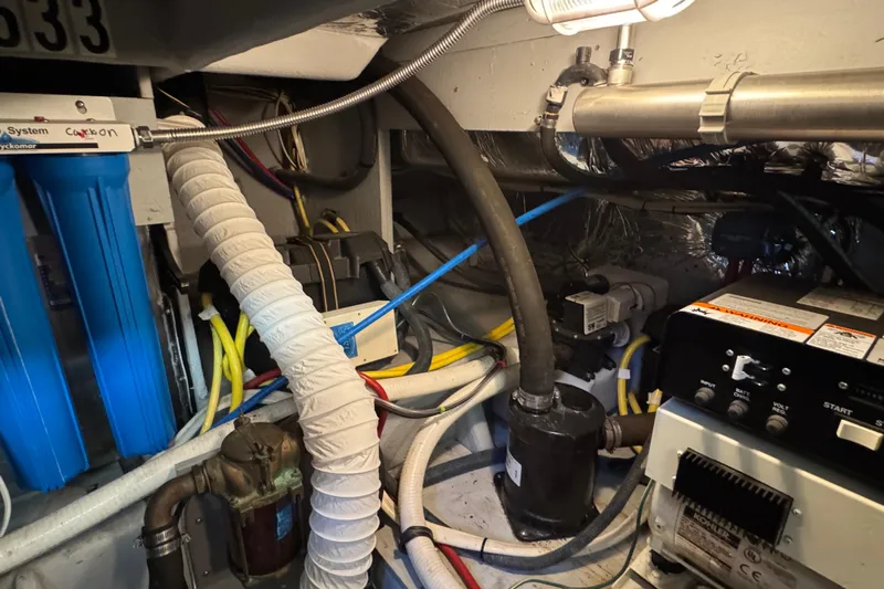 Comfort Zone Yacht Photos Pics Engine room of a 2005 Meridian 368 Motoryacht with various mechanical components and wiring.